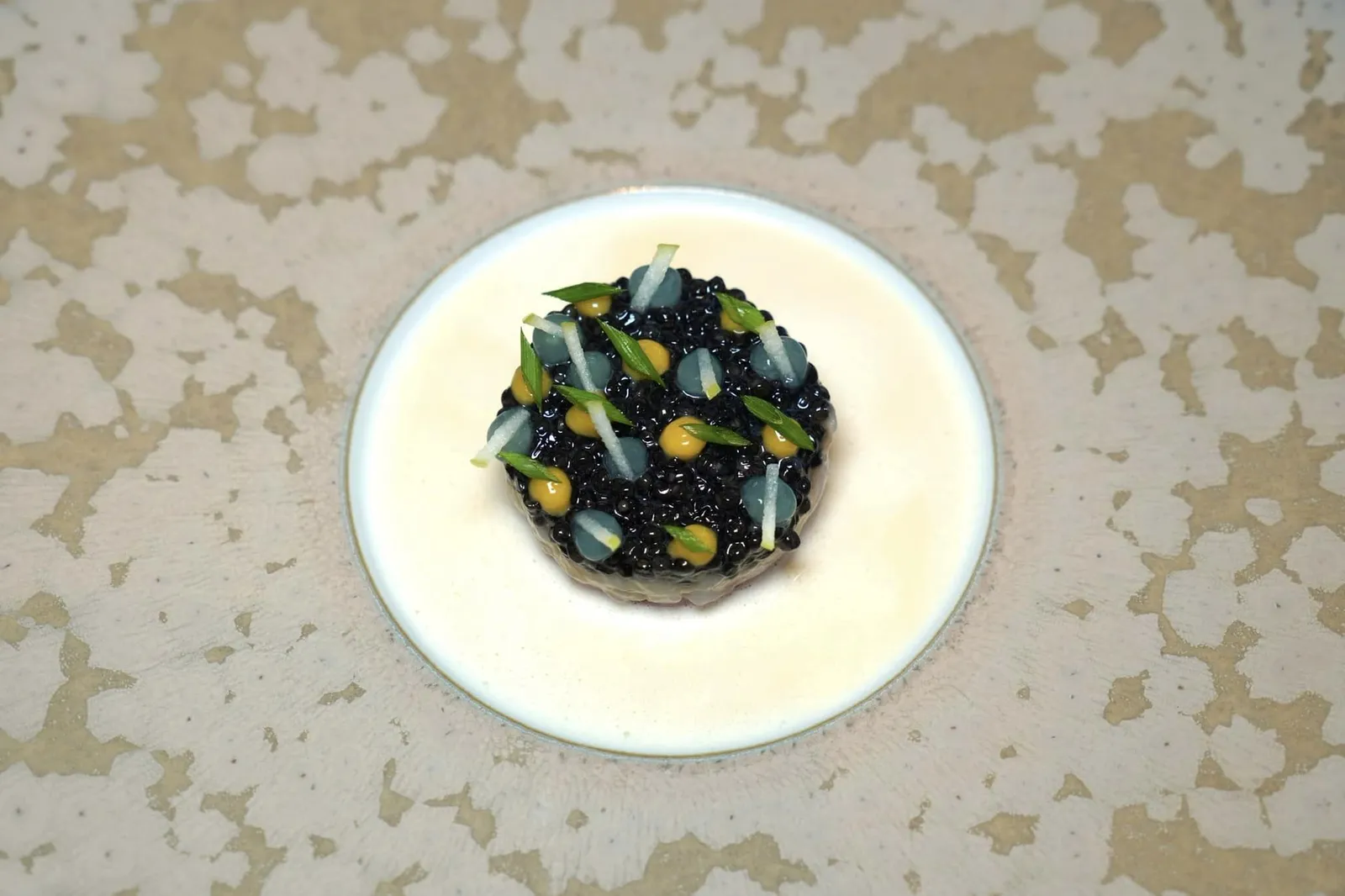 Caviar (Signature, Supplement 55 €) Holstein beef, langoustine ’Guilvinec‘, bread crust gravy เมนูเรียกน้ำย่อยที่ดีที่สุดในค่ำคืนนี้ต้องยกให้กับ Tartare ที่เตรียมมาจากเนื้อวัวนมสายพันธุ์ Holstein Friesian ซึ่งมีต้นกำเนิดมาจากจังหวัด Noord-Holland และ Friesland ของประเทศเนเธอแลนด์ เชฟสับเนื้อมาอย่างดีจนได้เนื้อสัมผัสอันแสนนุ่มละมุนชนิดหาใครเทียบได้ยาก ชั้นถัดมาคือเลเยอร์บาง ๆ ของกุ้ง Langoustine ซึ่งเป็นสินค้าขึ้นชื่อของเมือง Guilvinec ทางตะวันตกของประเทศฝรั่งเศสโดดเด่นด้วยเนื้อที่ให้รสชาติที่หวานกลมกล่อมโดยธรรมชาติ ชั้นบนสุดคือ Caviar คุณภาพสูงใส่มาแบบล้น ๆ ท็อปด้วยเจลสีเหลืองที่เตรียมมาจาก Egg Yolk หรือไข่แดงและเจลสีขาวขุ่นที่เตรียมขึ้นมาจาก Granny Simth Apple ช่วยเสริมรสชาติทั้งเปรี้ยว หวาน และมันได้อย่างลงตัว รอบ ๆ คือซอส Gravy สีเหลืองนวลที่เชฟเตรียมมาจาก Bread Crust หรือขอบขนมปังนั่นเอง ด้วยการผสมผสานกันอย่างลงตัวของสุดยอดวัตถุดิบระดับโลกทำให้ใครที่อยากสัมผัสจำเป็นต้องอับเกรดจากเมนูปกติอย่าง Fabergé Egg โดยมีค่าใช้จ่ายเพิ่มเติมจากราคาปกติถึง 55 € กันเลยทีเดียว (20/20)