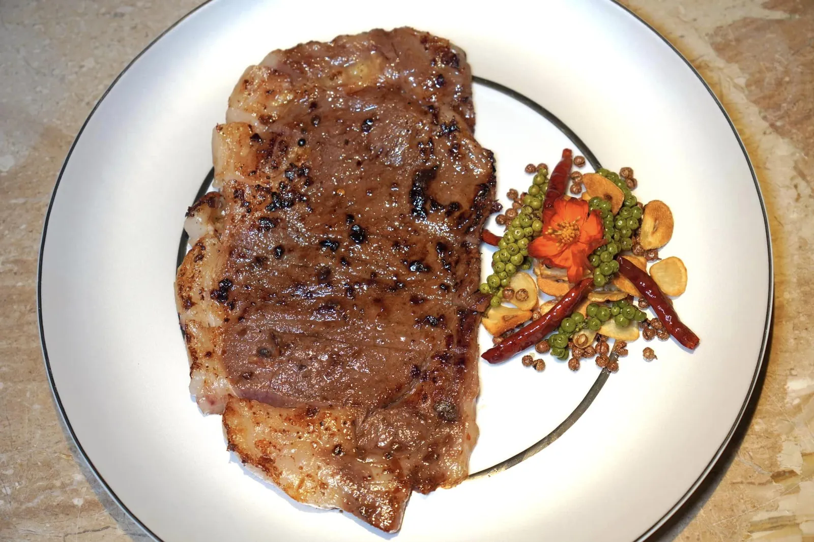 เนื้อวากิว A5 ซอสหม่าล่า (1,400+) Sautéed Wagyu Striploin with Mala Sauce เนื้อวัววากิวระดับ A5 จี่บนกระทะจนสุกได้เนื้อและแน่นอนว่าเนื้อก็นุ่มละลายในปากจริง ๆ พร้อมกับให้รสชาติและกลิ่นหอมเฉพาะตัวของพริกหม่าล่าแบบเสฉวนและกระเทียมเจียวกรอบ ๆ ของแท้