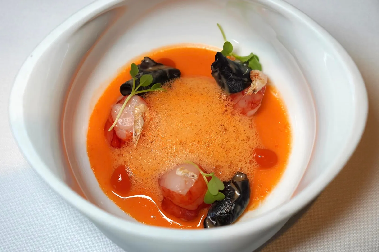 Tempered Scarlet Shrimp with its coral soup อีกหนึ่งคอร์สที่เชฟเตรียมออกมาได้โดดเด่นที่สุดในวันนี้คือคือกุ้งแดง Carabineros ซึ่งมีเนื้อสัมผัสนุ่มละมุนเฉพาะตัว ทั้งยังมีรสชาติหวานธรรมชาติ ด้านบนคือเห็ดเคี้ยวกรึบและ Camarones เป็นกุ้งชิ้นเล็ก ๆ เคี้ยวกรอบช่วยให้เกิดมิติทางเนื้อสัมผัสจากองค์ประกอบทั้งสามเมื่อรับประทานไปพร้อมกัน รอบ ๆ คือซุปสีส้มแดงหอมมันทำมาจากส่วนและเปลือกหัวของกุ้งแดง องค์ประกอบตรงกลางคือโฟมสีแดงทำมาจากพริกหวาน Rocoto Pepper ช่วยเพิ่มอโรม่าความหอมให้กับจาน จัดเป็นคอร์สที่ชูวัตถุดิบล้ำค่าหลายชนิดออกมาพร้อม ๆ กันได้อย่างไร้ที่ติโดยไม่มีใครโดดเด่นเกินเลยไปกว่ากัน สุดยอดมาก ๆ (20/20)