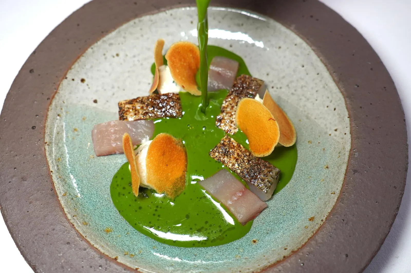 Féra, eau de cresson Fera, watercress water Fera เป็นปลาในสกุล Salmonidae ที่อาศัยอยู่ในน้ำจืดพบมากในพื้นที่แถบ Lake Geneva ทั้งฝั่งสวิสเซอร์แลนด์และฝรั่งเศส ในที่นี้เชฟนำปลาไปรมควันแล้วเผาจนสุกได้ระดับ จากนั้นเสิร์ฟมาคู่กับซุปผัก Watercress สีเขียวเข้ม ครีมสีขาวคือ Fera Fish Tarama และแผ่น Crispy Potato สีเหลืองนั่นเอง (19/20)
