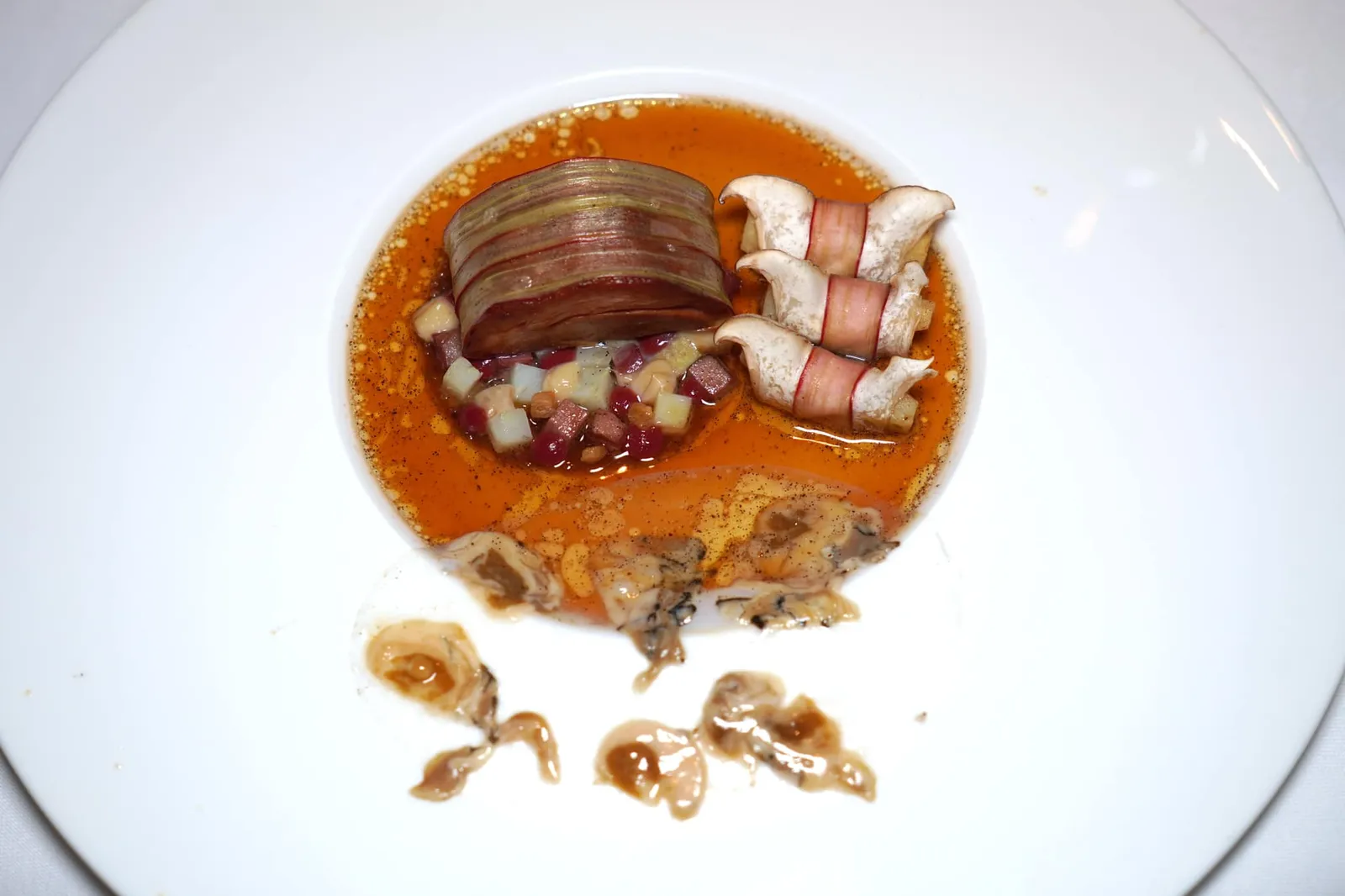 Lamb Oyster, Vanilla, Rhubarb, Eryngi, Artichoke อีกจานหนึ่งคือเนื้อลูกแกะส่วนสันคอให้เนื้อสัมผัสที่ต้องเคี้ยวอยู่บ้าง รอบ ๆ พันห่อด้วย Rhubarb ด้านล่างมีลักษณะเป็น Paste ที่ได้ความกรอบของเมล็ดสน ข้างกันคือ Artichoke เผาห่อด้วย Eryngi หรือเห็ดนางรมหลวงแล้วพันด้วย Rhubarb จนเกิดเนื้อสัมผัสที่แตกต่างกัน บริเวณขอบจานยังมีแผ่นใส ๆ ทำมาจากเนื้อหมึก Cuttlefish ฝานบางท็อปด้วยหอยนางรมแล่บางที่เมื้อเคี้ยวแล้วจะได้ทั้งความนุ่มและความหนึบไปพร้อม ๆ กันนั่นเอง (18/20)
