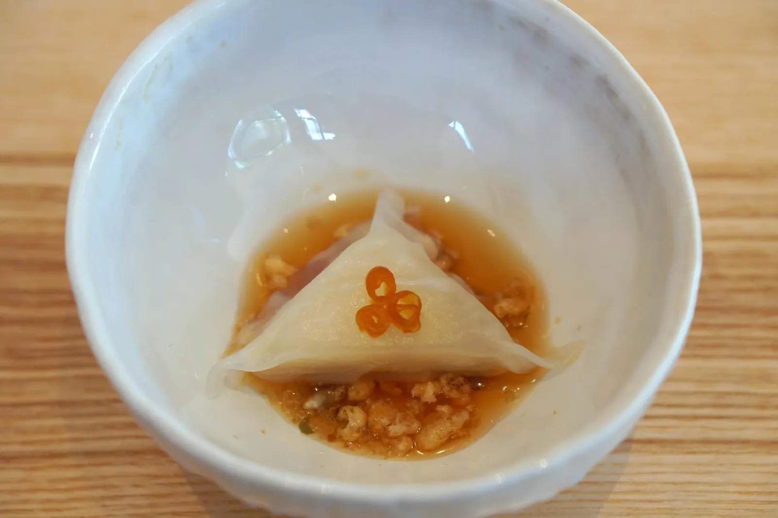 洋梨の餃子 スパイスおこし Williamine and pear, cold squash broth, crispy and spicy Okoshi ถัดมาคือ Pear gyoza ขนมเกี๊ยวรูปสามเหลี่ยมที่ด้านในสอดไส้ลูกแพร์ ราดด้วยน้ำซอสสีส้มทำจาก Butternut squash หรือฟักทองน้ำเต้าหู้เสิร์ฟมาแบบเย็น ขนาบข้างกันคือโอโคชิหรือบิสกิตกรอบแบบญี่ปุ่น ทานกับ ข้าวกรอบ เมล็ดฟักทอง และพริก (16/20)
