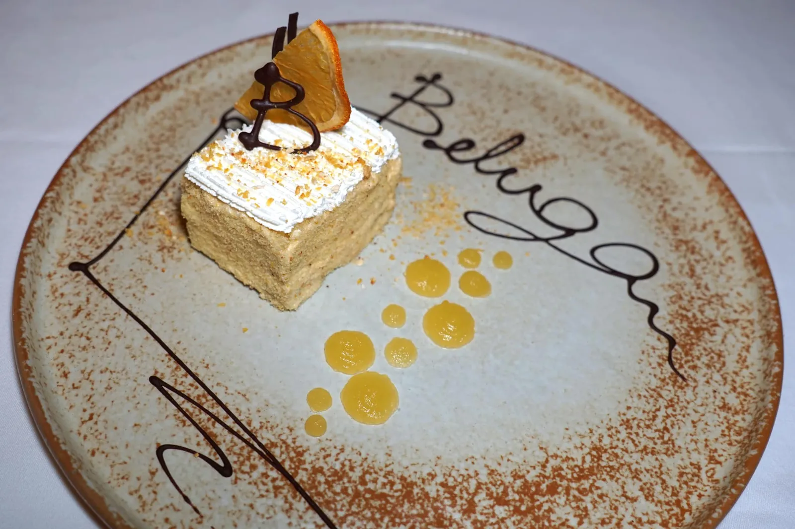 SACRIPANTINA (250++) Genoise Cake Soaked Grand Marnier - Chocolate Cream - Orange Sauce “ซาคริปันติน่า” เป็นเค้กพื้นบ้านจากเมือง Genoa บ้านเกิดของเชฟ สูตรต้นตำรับถูกคิดค้นโดย Giovanni Preti ในปี 1851 และตั้งชื่อตาม Sacripante ตัวละครในบทกลอนของ Ludovico Ariosto นักกวีชื่อดังช่วงยุค Renaissance เนื้อเค้กนุ่ม ละมุน มีกลิ่นหอมจากการแช่ในกร็องมานิเย่ร์ ด้านบนทอปด้วยครีมช็อกโกแลต ทานกับซอสส้มรสเปรี้ยวหวาน