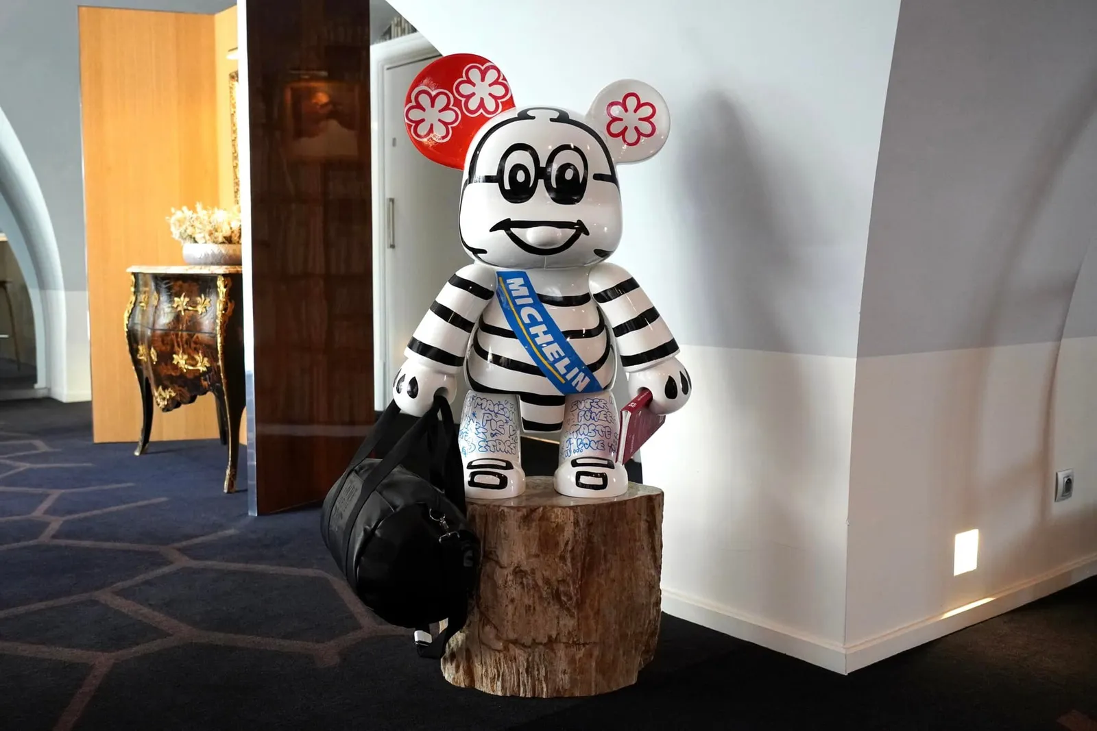 ข้างกันมีหุ่นรูป Mickey Mouse ที่มีหน้าตาเป็น Bibendum มาสคอตของ MICHELIN ยืนต้อนรับลูกค้าทุก ๆ คน