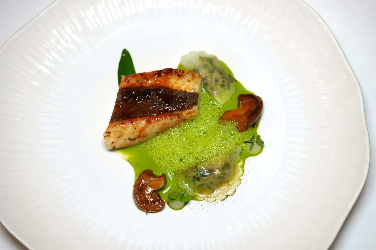 John Dory ortu maritimu citron, whelks, lovage สำหรับจานปลาเชฟนำเสนอ Saint Pierre หรือที่เรารู้จักกันในชื่อของปลา John Dory เชฟนำมา Infused ด้วย Green Cardamom ย่างจนเนื้อสัมผัสนุ่มหนึบได้ระดับ ไฮไลท์ที่ทำเอาเราตกใจคือเนื้อสัมผัสของหนักปลาที่นุ่มหนึบหนับจนคล้ายกันกับแคบหมูบ้านเรา ข้างกันคือ Citrus Raviole ให้รสชาติออกเปรี้ยวและขมเล็กน้อยเสริมด้วยอโรมาทะเลของสาหร่าย สุดท้ายคือซอส Dashi ที่มีส่วนผสมของ Cardamom และ Lovage เติมแต่งโทนกลิ่นและอโรมาของจานให้สมบูรณ์มากยิ่งขึ้น (19/20)