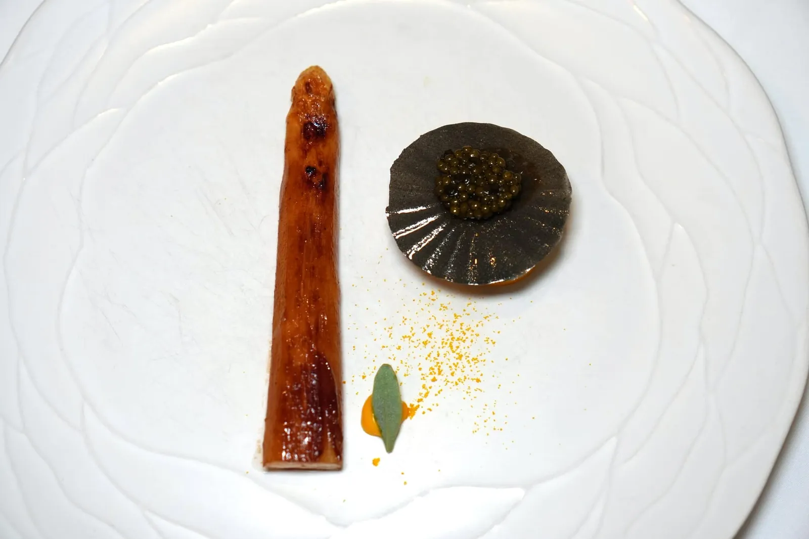 White asparagus golden crunch saffron, beeswax, Oscietre caviar จานนี้คือหน่อไม้ฝรั่งขาวจาก Mount Ventoux ซึ่งเป็นภูเขาในแถบ Provence เชฟนำไปหมักกับสาเกแล้วย่างด้วยความร้อนสูง (Cooked on the Plancha) จนได้เนื้อสัมผัสกรอบบริเวณผิวในขณะที่เนื้อด้านในยังคงฉ่ำหวาน ข้างกันคือองค์ประกอบของ Saffron Cream และ Orange Blossom หรือดอกส้ม คั่นกลางด้วยแผ่นกรอบทำจากข้าวเคลือบด้วยไขผึ้งช่วยเพิ่มมิติทางเนื้อสัมผัส ด้านบนคือ Kaviari Oscietra Caviar หนึ่งในแบรนด์คาเวียร์คุณภาพสูงที่พบได้ในห้องอาหารระดับสูงทั่วโลกให้รสชาติกลมกล่อมทั้งยังชูความหวานของหน่อไม้ฝรั่งให้โดดเด่นยิ่งขึ้นอีกด้วย (19/20)