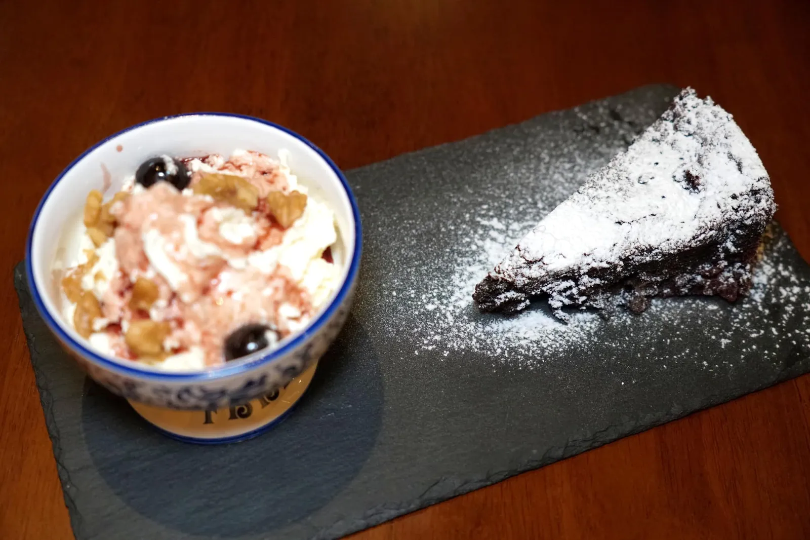 Torta Barozzi Noci E Amarene (320++) Vignola chocolate, almond and walnuts crumbly cake served with whipped cream and Amarene. “ตอต้า บาโรซชี่” เป็นของหวานขึ้นชื่อที่ถูกคิดค้นขึ้นโดยเชฟของหวานนามว่า Eugenio Gollini ในปี ค.ศ. 1886 โดยให้ชื่อเพื่อเป็นเกียรติแก่สถาปนิคชื่อดังนามว่า Jacopo Barozzi ตัวขนมมีลักษณะเป็นเค้กช็อกโกแลตและมีองค์ประกอบสำคัญคือถั่วอัลมอนต์และถั่ววอลนัทช่วยเพิ่มความกรอบขณะรับประทาน ข้างกันคือวิปปิ้งครีมหอมมันที่มีส่วนผสมของ Amarena cherry ปัจจุบันเมนูนี้ยังคงมีขายอยู่ในร้านขนมหวานต้นตำรับอย่าง Pasticceria Gollini ในเมือง Vignola รวมไปถึงร้านขนมทั่ว ๆ ไปรอบ ๆ เมือง Modena อีกด้วย (13/20)