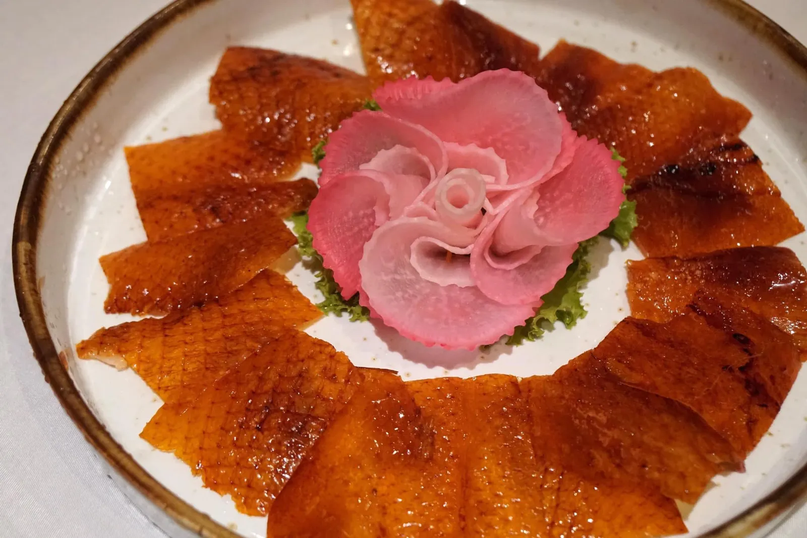เป็ดปักกิ่ง (1285++) Crispy Peking duck skin, served with paper-thin rice pancakes, spring onion, cucumber and plum sauce
