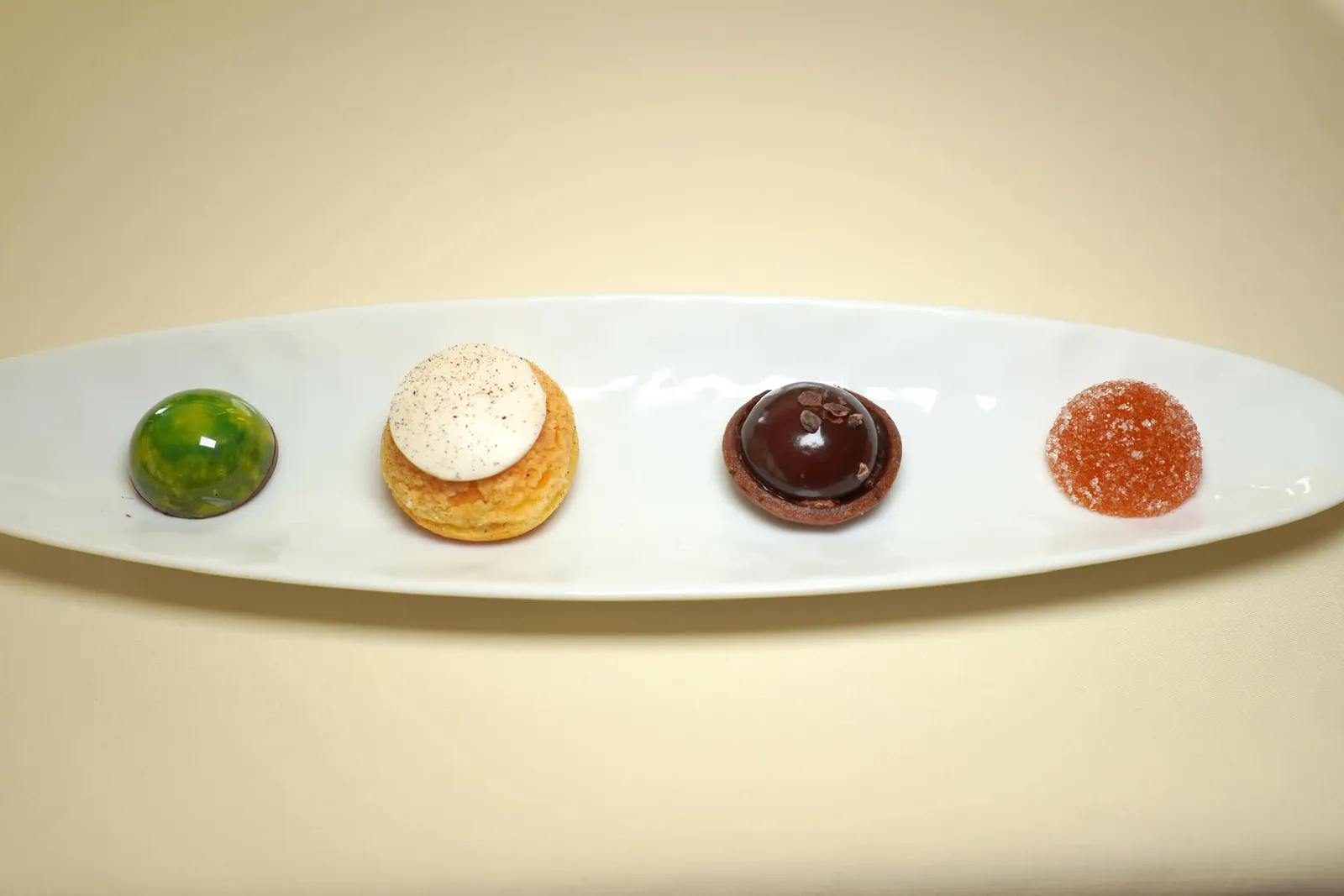 Petit-four รายการ Petit-four ประกอบไปด้วย Chocolate Infused with Ginger and Lime, French Choux with Tahiti Vanilla Cream, Dark Chocolate และ Mango and Passionfruit Pâte de Fruits
