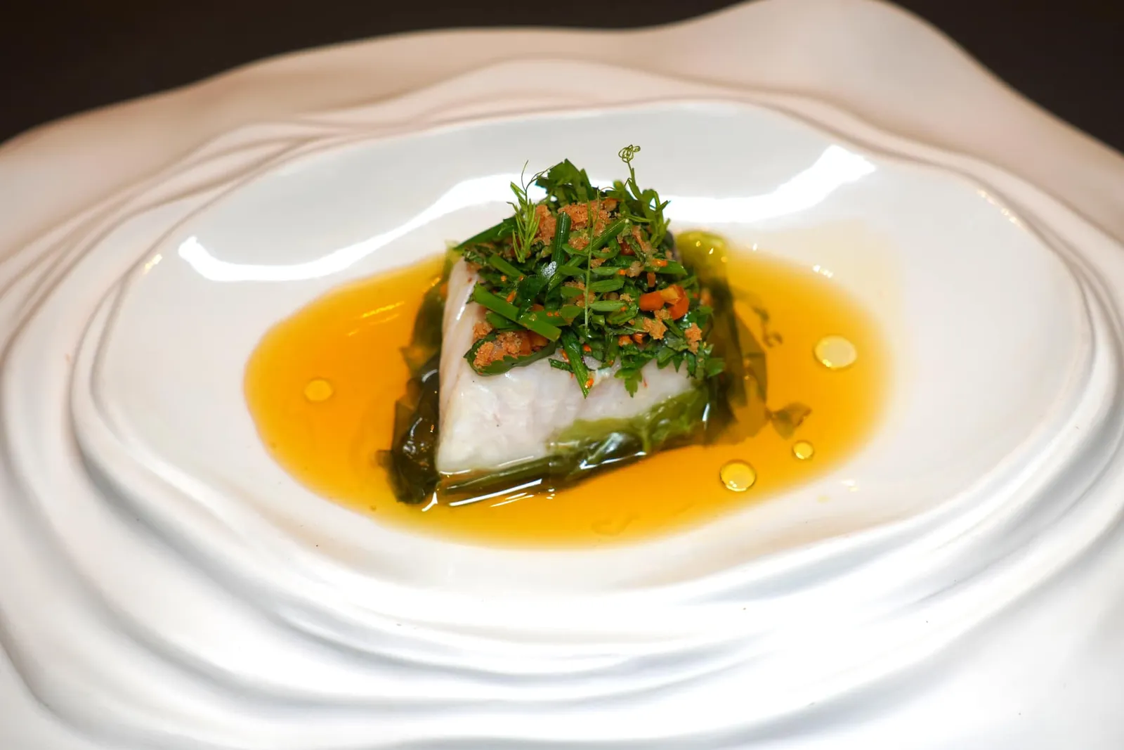 III.Atlantic Merluza "Caribbean-inspired" with sea spinach, mint, dried papaya and roasted riceปลา Atlantic Merluza มีจุดเด่นที่เนื่อสัมผัสซึ่งค่อนข้างแน่นแต่ไมากระด้าง เชฟอาศัยแรงยันดาลใจจากแถบแคริบเบียนโดยการท็อปด้านบนด้วย Roasted Rice หรือข้าวคั่ว นอกจากนี้ยังมัมิ้นต์ มะละกอแห้ง และผักโขมทะเลให้เนื้อสัมผัสที่แตกต่างกัน ด้านล่างรองด้วยสาหร่ายทะเล เชฟเสิร์ฟมากับ Exotic Sauce มีบักษณะเป็นซอสเสาวรสรสเปรี้ยวและน้ำมันเลมอน เมื่อรับประทานครบทุกองค์ประกอบแล้วชวนนึกถึงเมนูลาบอย่างไทยในรูปแบบที่ไม่เผ็ดอยู่เหมือนกัน (17/20)