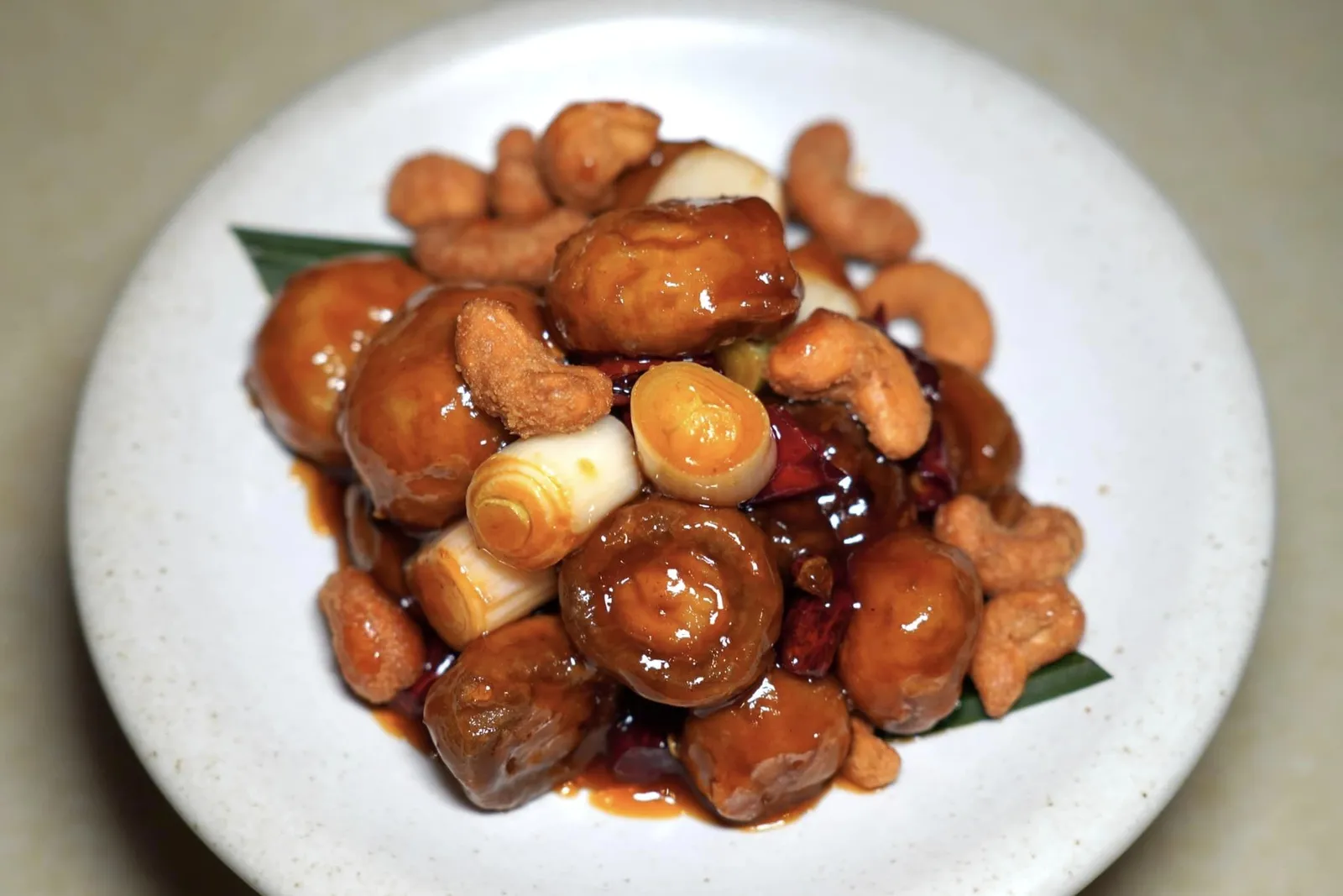 宫保小圆宝 (58 CNY+)Kung Pao White Button Mushroomsเห็ดกระดุมที่เชฟนำมาเสิร์ฟในสไตล์กงเปาแทนที่เนื้อไก่แบบดั้งเดิม น้ำซอสเปรี้ยวหวานเคลือบชิ้นเห็ดพอเหมาะ นอกจากนี้ยังมีเมล็ดมะม่วงหิมพานต์คั่วกรอบ ๆ ใส่มาอีกด้วย (14/20)