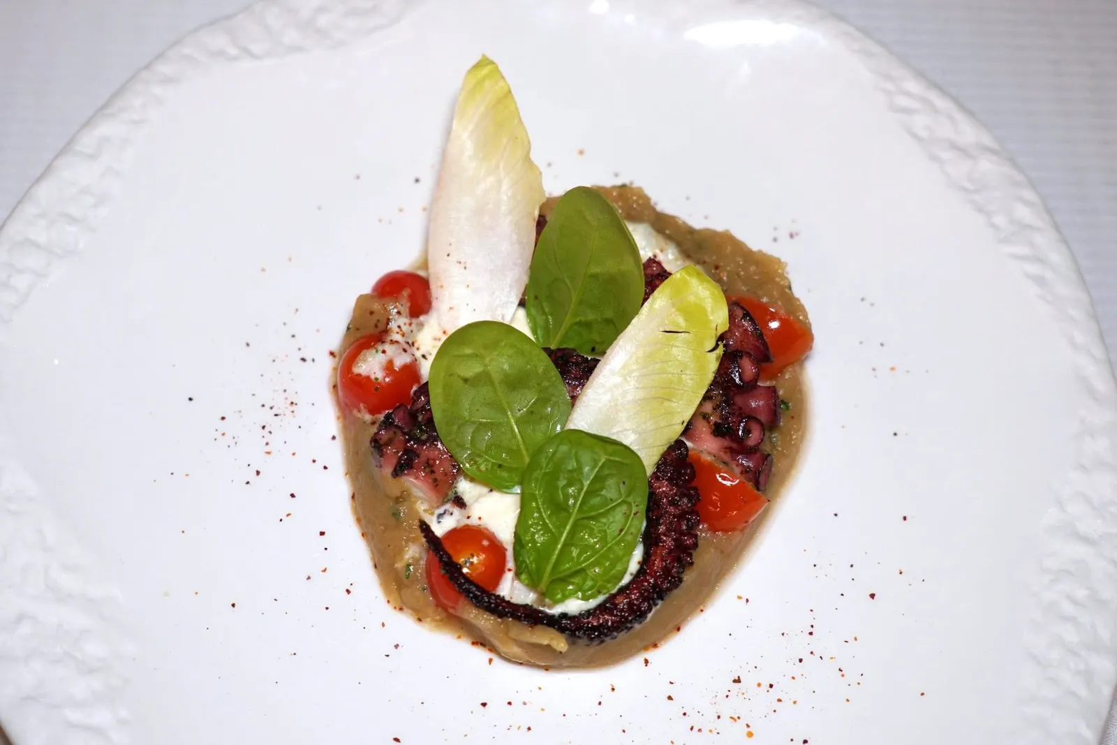 OCTOPUS TENTACLE (800++)Grilled and served with smoked eggplant mash and stracciatellaหนวดหมึกยักษ์ย่างมาสุกกำลังดีคลุกเคล้ากับชีส Stracciatella และมะเขือบดเนื้อเนียน