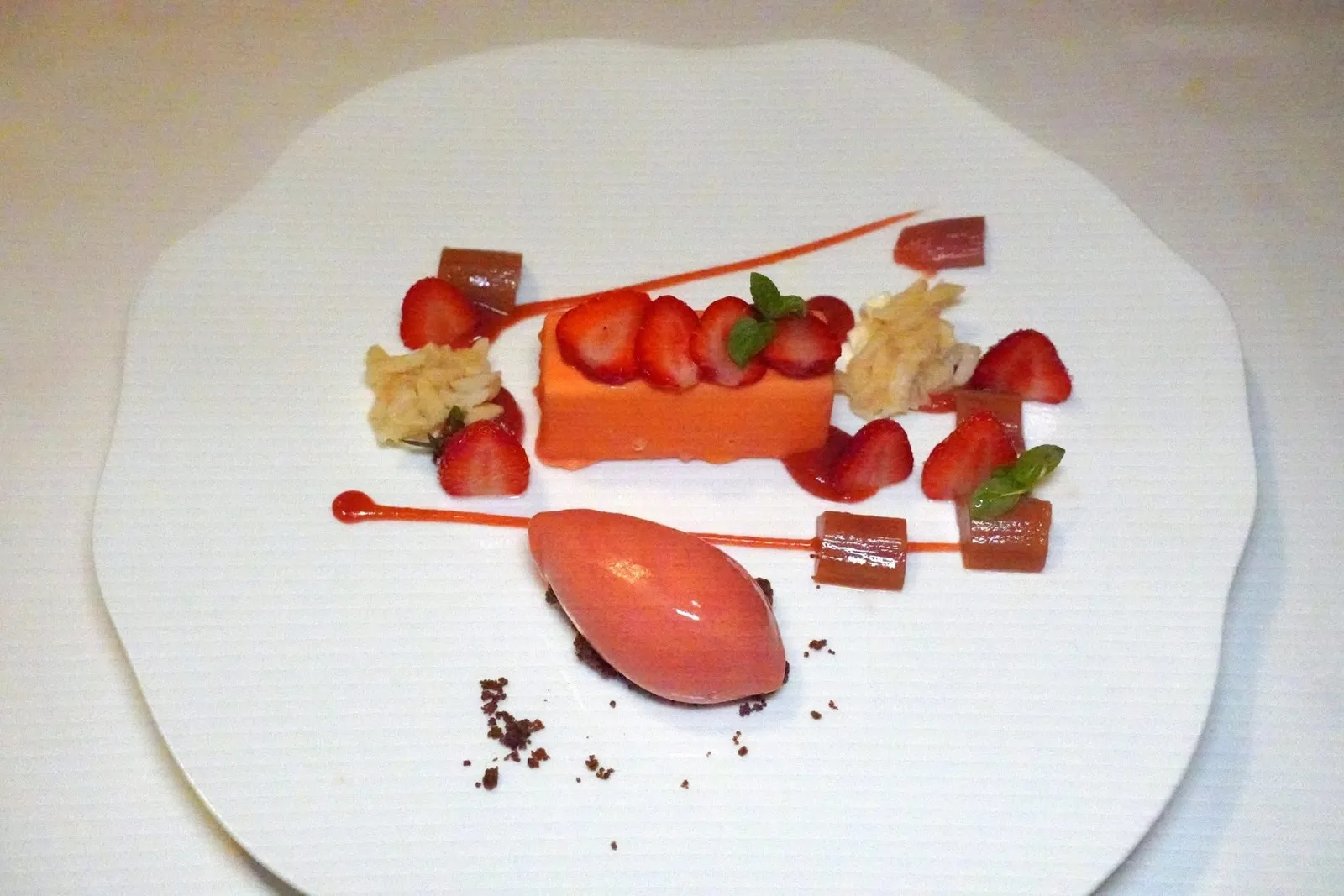Mandeldelizie - Rhabarber geschmort - Erdbeeren - Salzmandeln (18 €)Almond delicacy - braised rhubarb - strawberries - salt almondรูบาร์บที่ผ่านการตุ๋นจนนุ่มและกรอบเบา ๆ เสริมด้วยอโรมาหอม ๆ ของถั่วอัลมอนด์ในหลากหฃายรูปแบบและเนื้อสัมผัส ยังมีอัลมอนด์เค็ม นอกจากนี้ยังมีความเปรี้ยวหวานของไอศกรีมและชิ้นสตรอว์เบอร์รี่เข้ากันได้อย่างลงตัว (15/20)