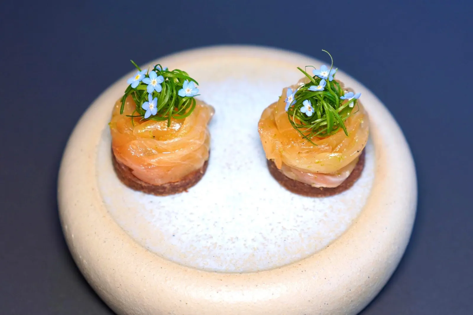 TROUT BELLYfermented buckwheat, asparagusคอร์สนี้คือแพนเค้กบัควีทหมักเสิร์ฟมากับครีมอัลมอนด์ ด้านบนคือท้องปลาเทร้าต์จากฟาร์มในเมือง Bohinjska Bistrica ที่ผ่านกระบวนการหมักเพียงเล็กน้อย เชฟเพิ่มมิติทางเนื้อสัมผัสด้วยหนังปลาเทร้าต์กรอบรวมไปถึงหน่อไม้ฝรั่ง จากนั้นท็อปด้านบนด้วย Chive หรือต้นหอมแล้วตกแต่งจานด้วยดอก Forget Me Not (20/20)