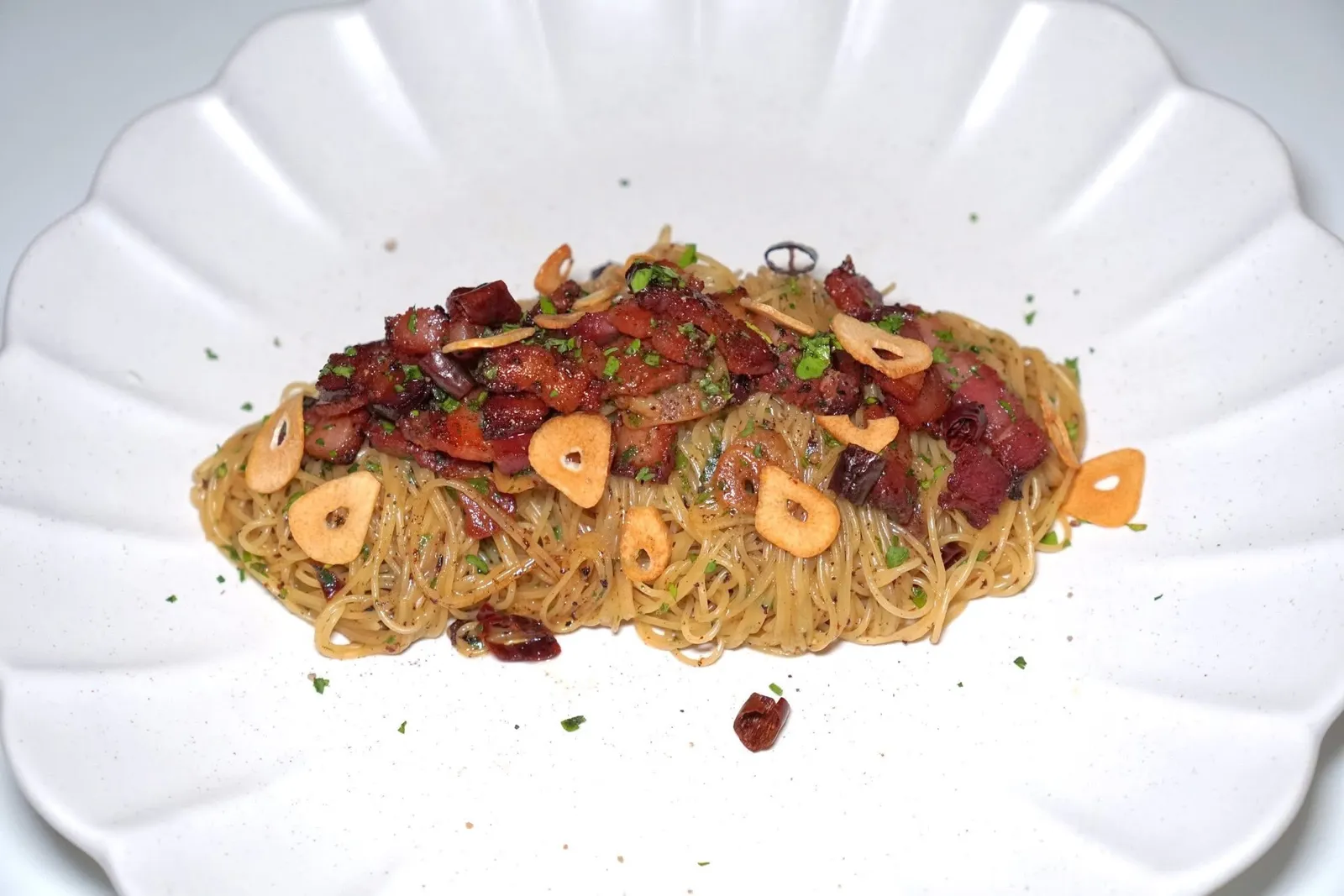 Bacon AOP Capellini (350++)larder thick-cut bacon, extra virgin olive oil, garlic & dried chilliesพาสต้าเส้นคาเปลลินีคลุกเคล้ากับกระเทียมทอด พริกแห้ง และเบคอนหั่นหนาแบบเต็มปากเต็มคำ (13/20)