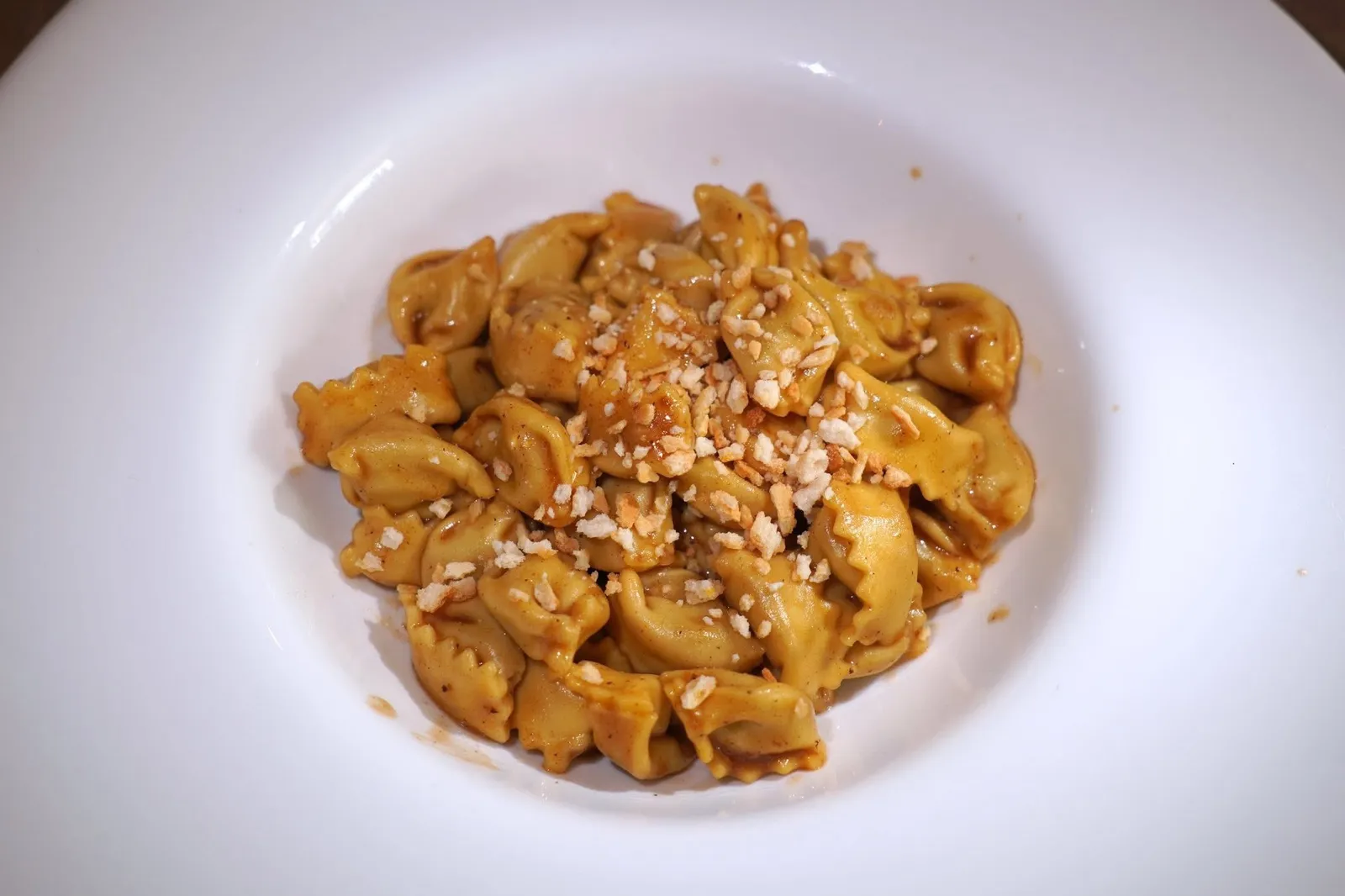 "Agnolotti del Plin" Pasta (15 €)with roast sauce, thyme and breadstick crumbsAgnolotti del Plin เป็นพาสต้าทรงเกี๊ยวท้องถิ่นของภูมิภาค Piedmont ด้านในสอดไส้เนื้อสัตว์ รอบ ๆ คือซอสที่มีความหอมของใบไทม์และความกรอบของเกล็ดขนมปัง (14/20)